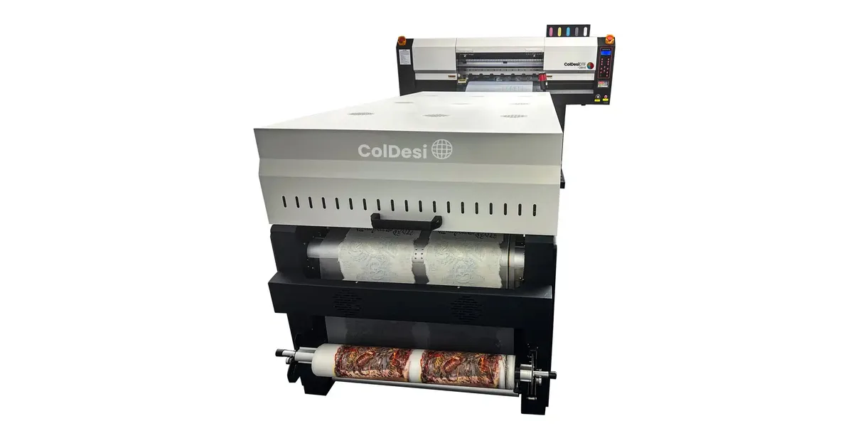 ColDesi 24H4 roll-to-roll DTF printer mounted behind its 24-inch powder shaker and dryer with printed film on the take-up roll