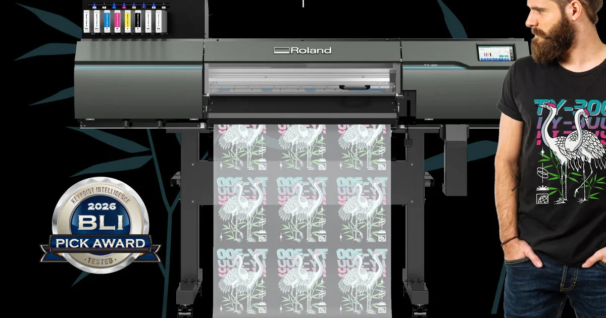 Roland TY-300 DTF printer on its stand printing a roll of crane transfers, with the BLI 2026 Pick Award badge